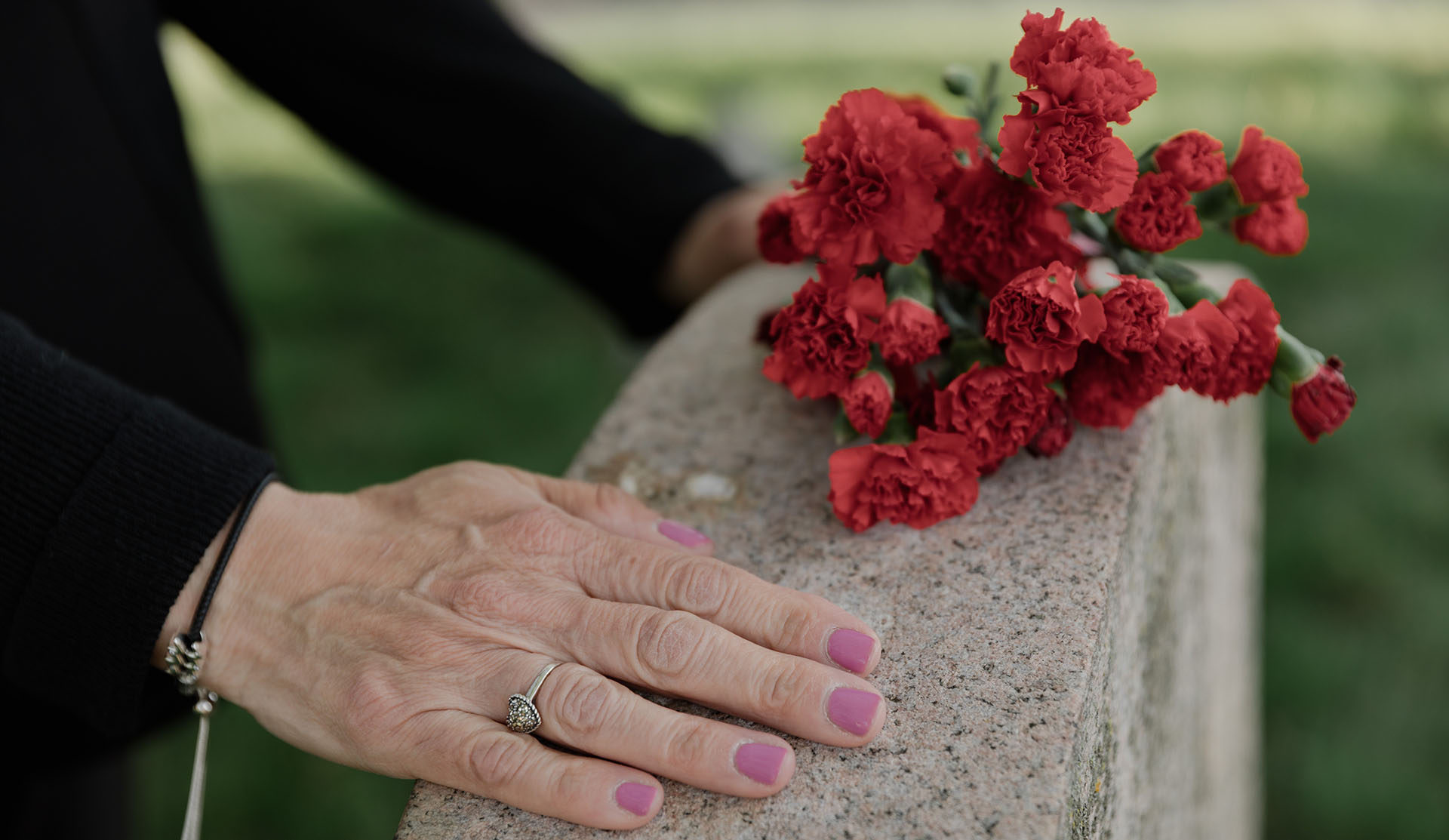 woman with flowers at grave