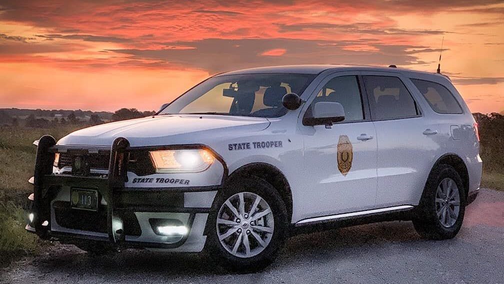 state trooper vehicle with sunset in background