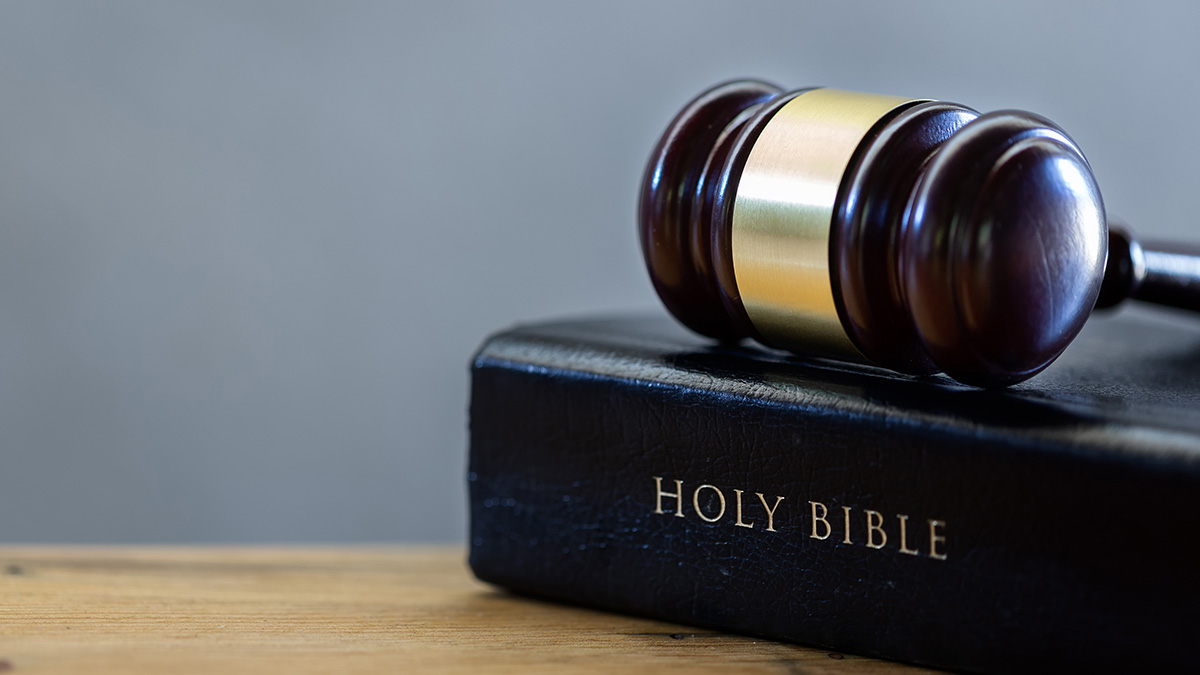 a judge's gavel on top of a christian bible