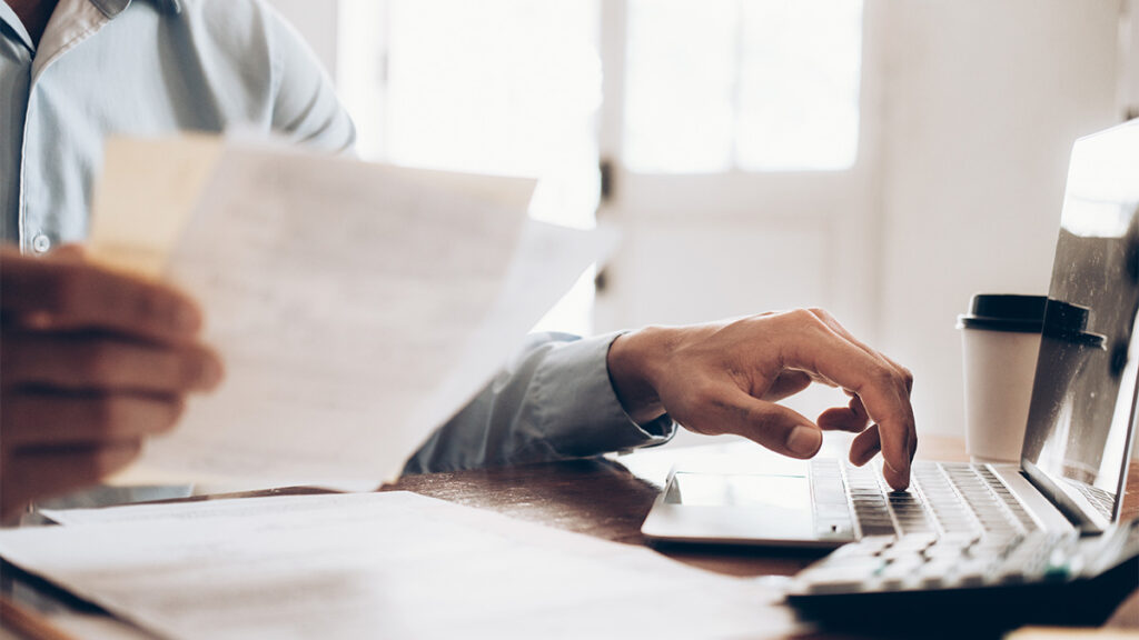 lawyer at desk calculating billing hours and fees