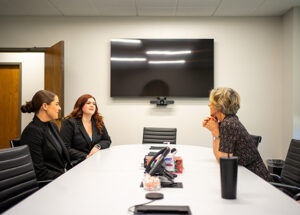 JHC attorney talking with UMKC Law students in the conference room table at JHC's Overland Park office