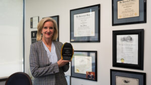 Attorney Dionne Scherff holding the Clarence Darrow Award.